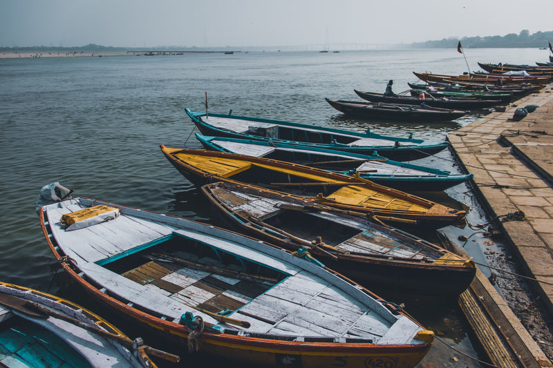 boats docked on shoreline in body of water